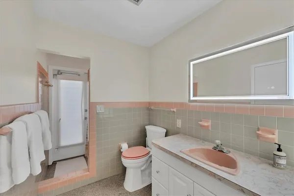 a bathroom with a shower and a glass door shower