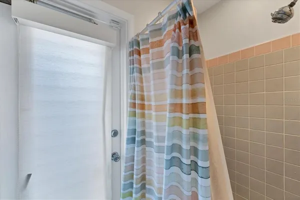 a bathroom with a tub and shower