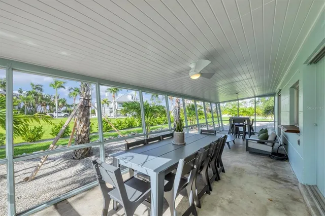 a view of a patio with a table chairs and backyard