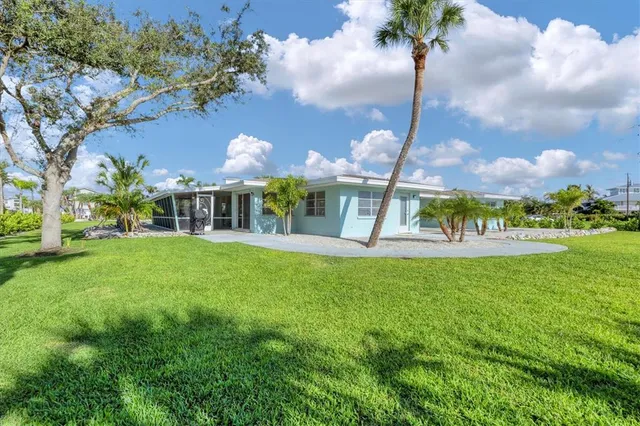 a front view of house with yard and green space