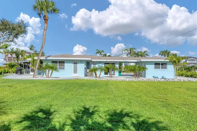 a view of a fountain in front of a house with a big yard
