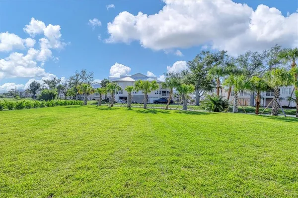 an aerial view of a house with a garden and lake view