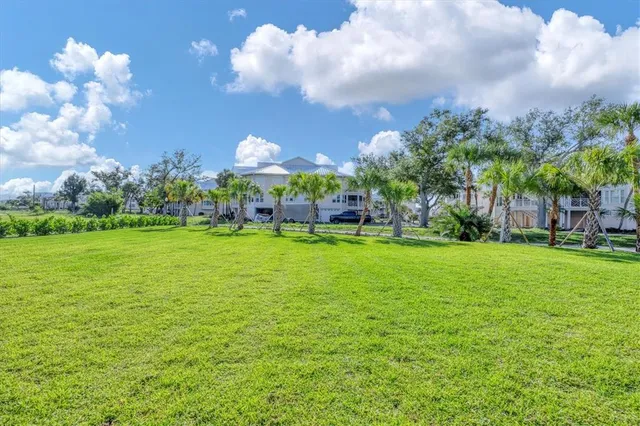 an aerial view of a house with a garden and lake view