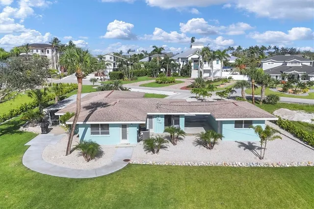 an aerial view of a house with garden space and ocean view