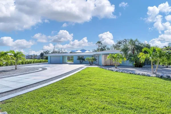 a view of a house with a yard and a garden