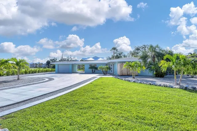 a view of a house with a yard and a garden