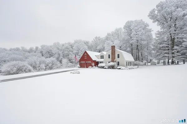 front view of house with yard and trees in the background