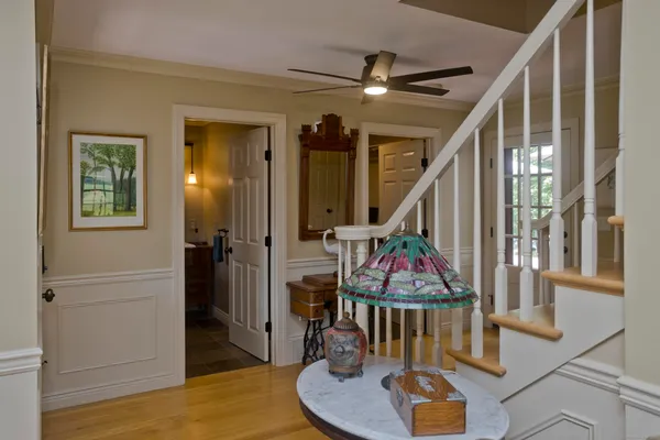 a view of a livingroom with furniture mirror and wooden floor