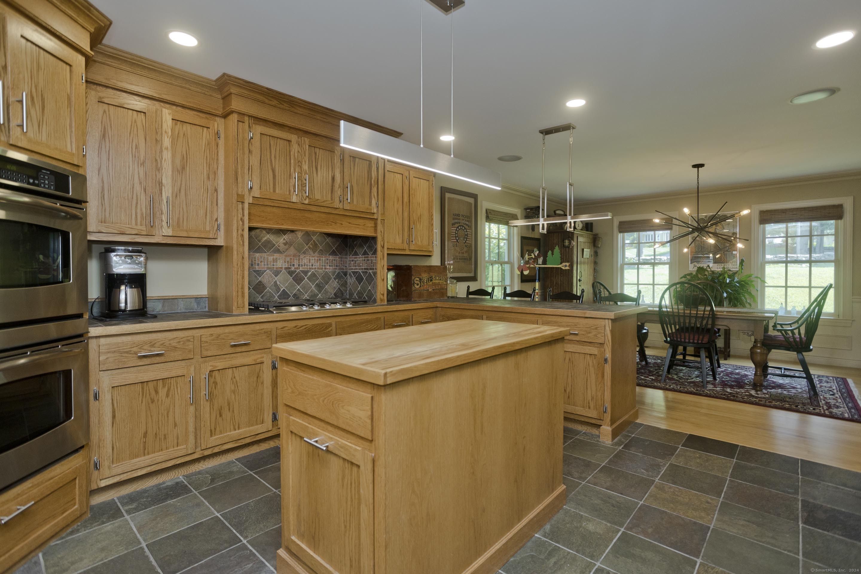 180 Leonard Road Stafford, CT 06076 - Photo 17 of 39 a kitchen with kitchen island granite countertop a sink counter top space appliances and cabinets
