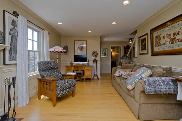 a living room with lots of furniture and view of kitchen