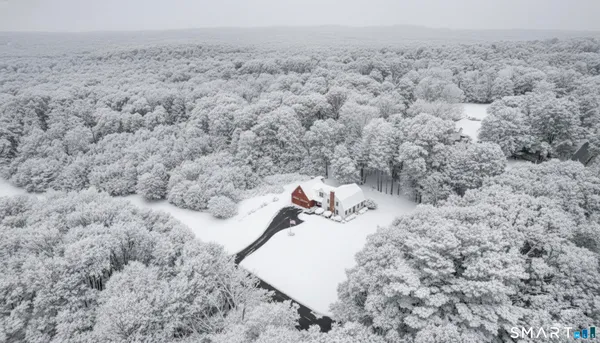 a view of a house with a snow on the road