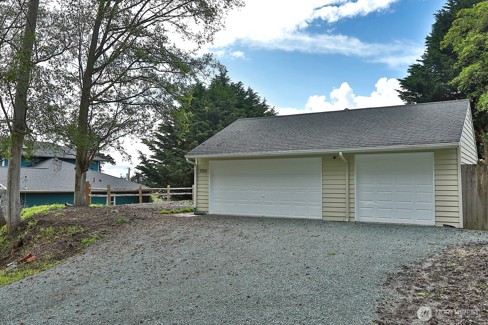 3760 Periwinkle Road Clinton, WA 98236 - Photo 29 of 34 a view of a house with a yard and garage