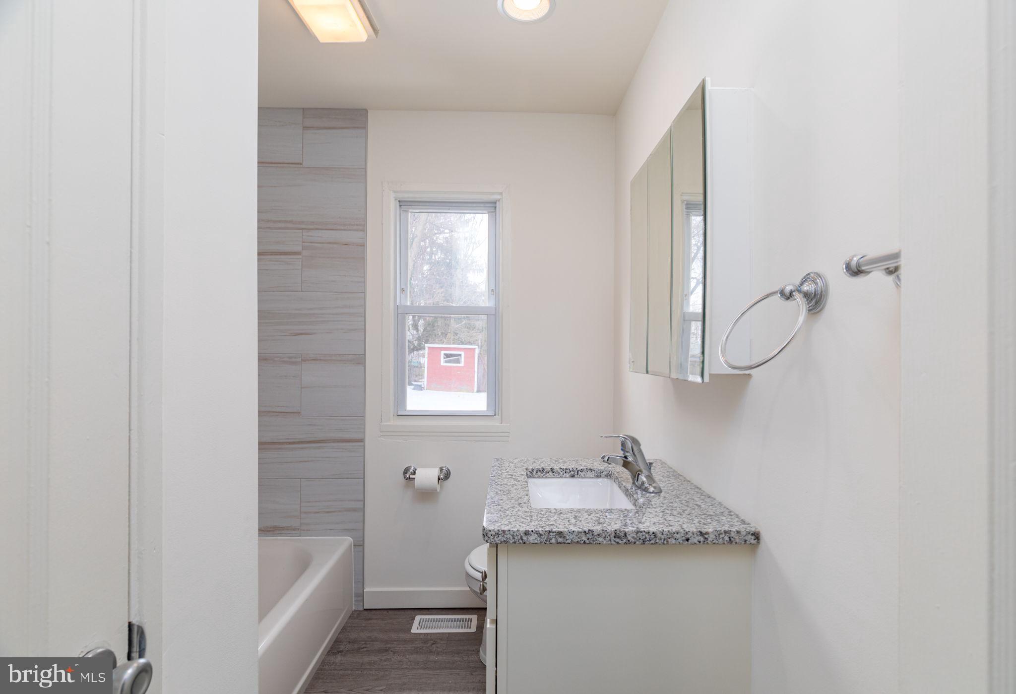 8 South Reed Street Bel Air, MD 21014 - Photo 9 of 21 a bathroom with a granite countertop sink a toilet and shower