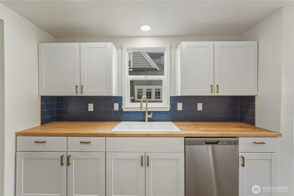 a kitchen with a refrigerator and a stove top oven