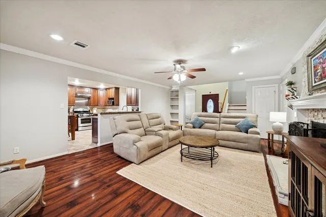 a living room with furniture and a wooden floor