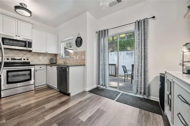 a bathroom with a double vanity sink toilet and shower