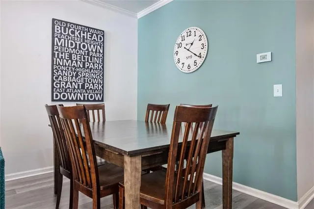 a view of a dining room with furniture and wooden floor