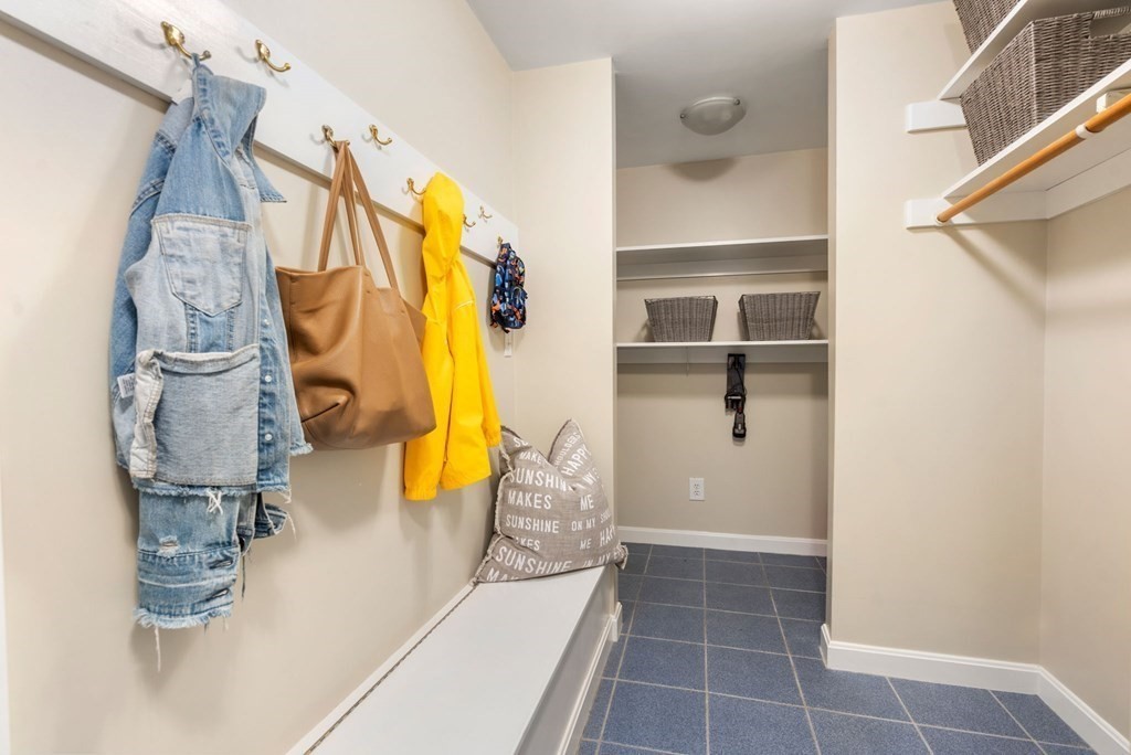 26 William Street Needham, MA 02494 - Photo 19 of 35 a view of walk in closet with clothes and shoes