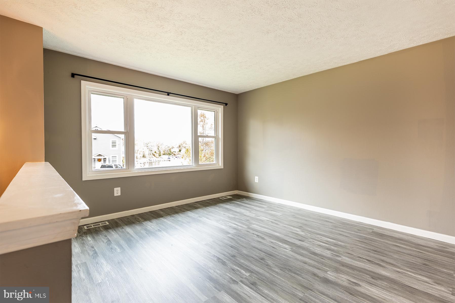 847 Harbor View Terrace Annapolis, MD 21409 - Photo 19 of 42 an empty room with wooden floor and windows