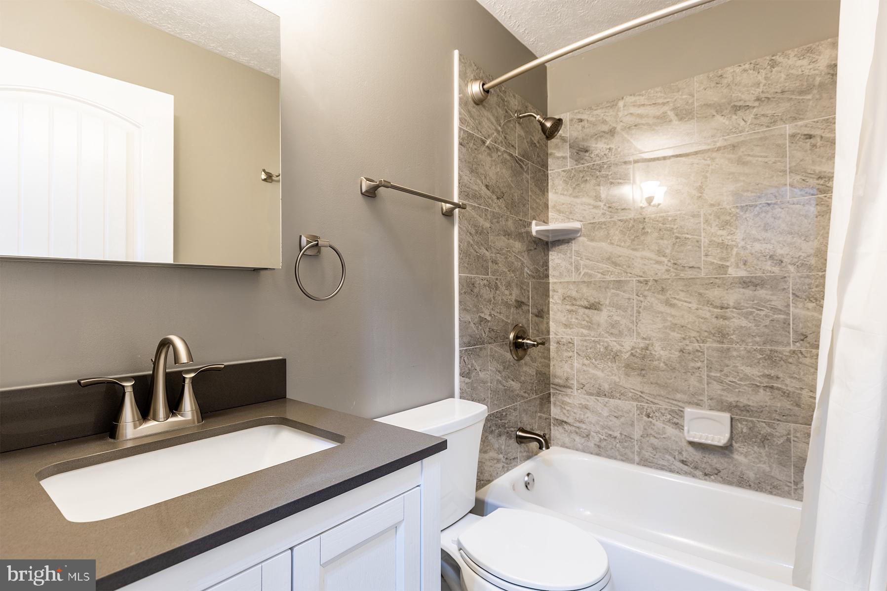 847 Harbor View Terrace Annapolis, MD 21409 - Photo 26 of 42 a bathroom with a sink vanity granite toilet tub and shower