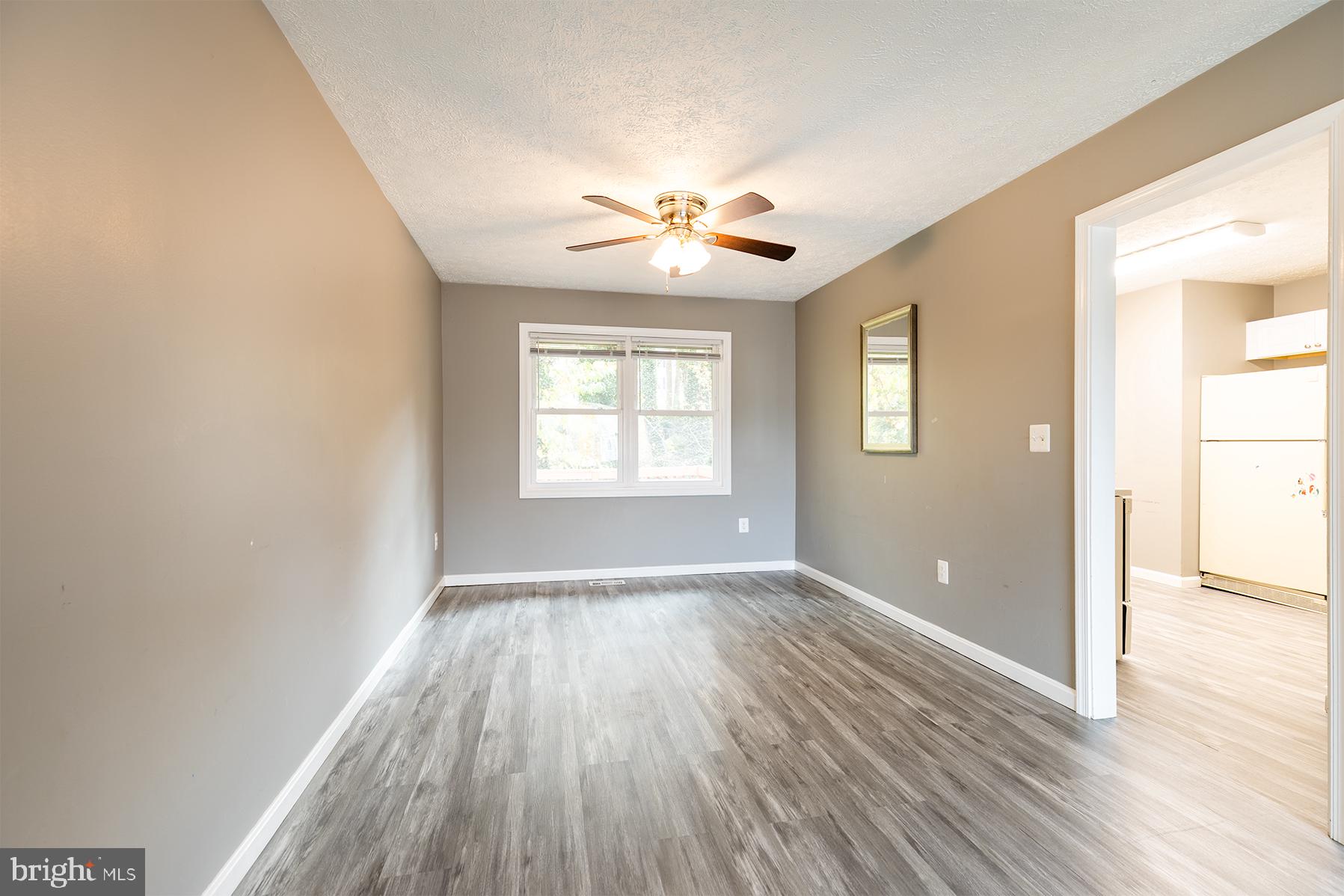 847 Harbor View Terrace Annapolis, MD 21409 - Photo 40 of 42 an empty room with wooden floor chandelier fan and windows