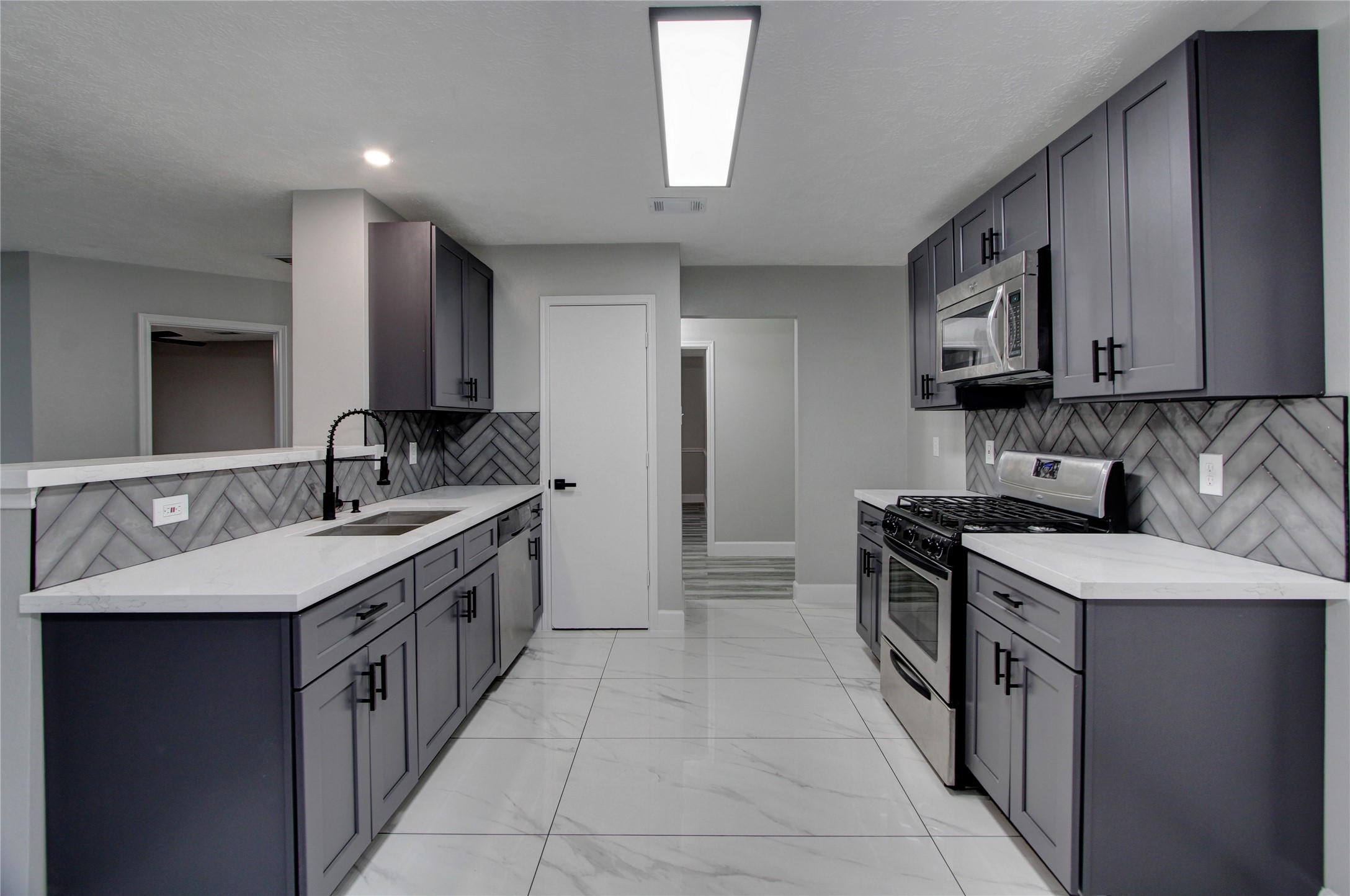 3646 Nutwood Lane Spring, TX 77389 - Photo 2 of 14 This kitchen boast of ample cabinet space, upgraded floors and herringbone backsplash.