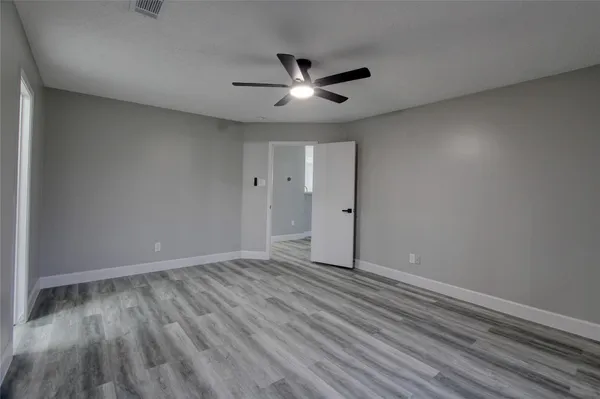a view of an empty room and wooden floor