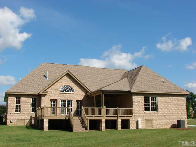 1137 Wakefield Farm Road Zebulon, NC 27597 - Photo 2 of 10 Covered Porch and large deck area. Large back yard.
