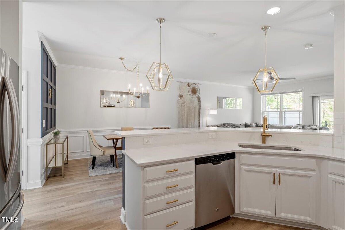 225 Mayfield Drive Apex, NC 27539 - Photo 12 of 41 a kitchen with cabinets a sink dishwasher and a stove with wooden floor