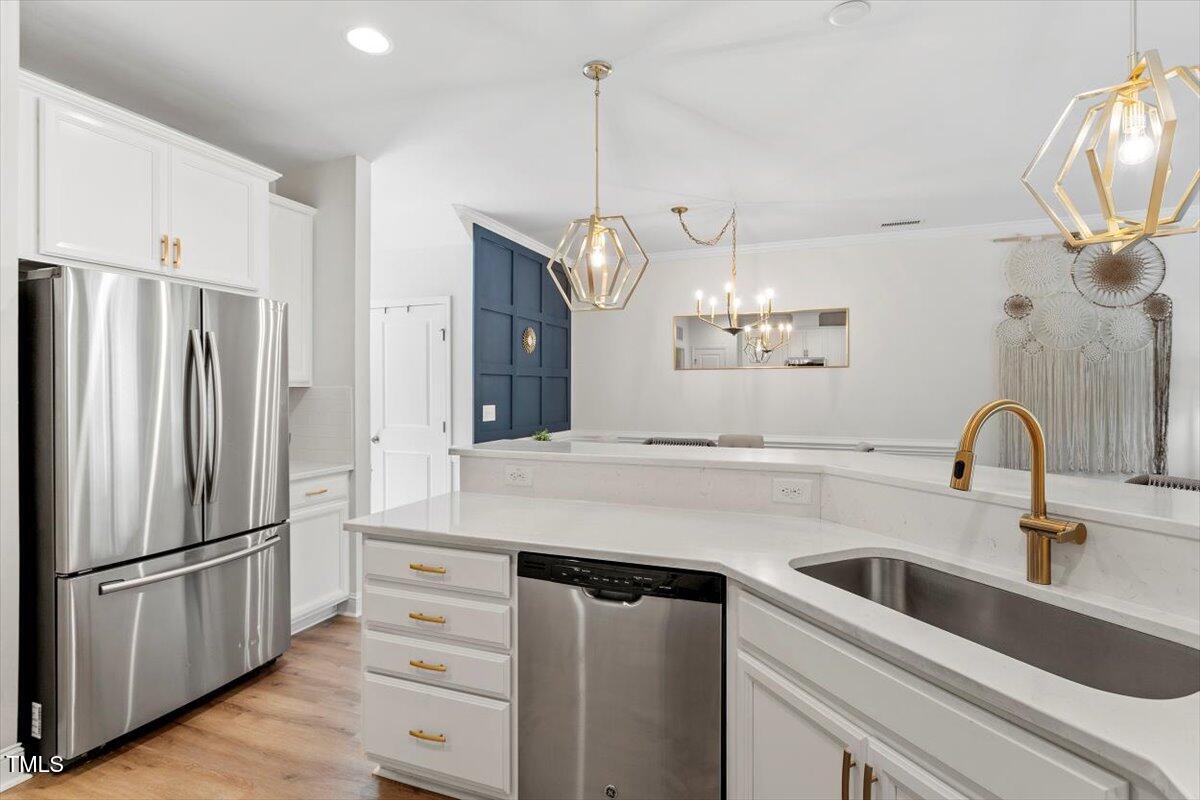 225 Mayfield Drive Apex, NC 27539 - Photo 13 of 41 a kitchen with refrigerator cabinets and wooden floor