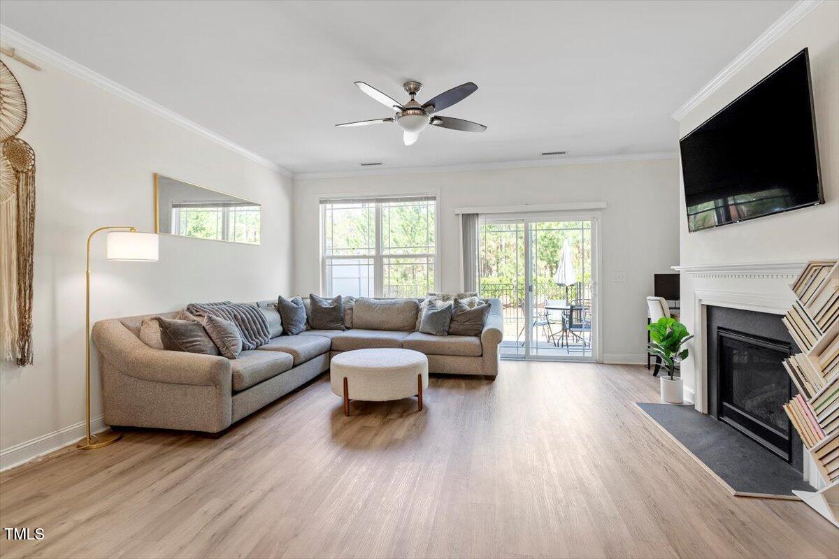 225 Mayfield Drive Apex, NC 27539 - Photo 16 of 41 a living room with fireplace furniture and a flat screen tv