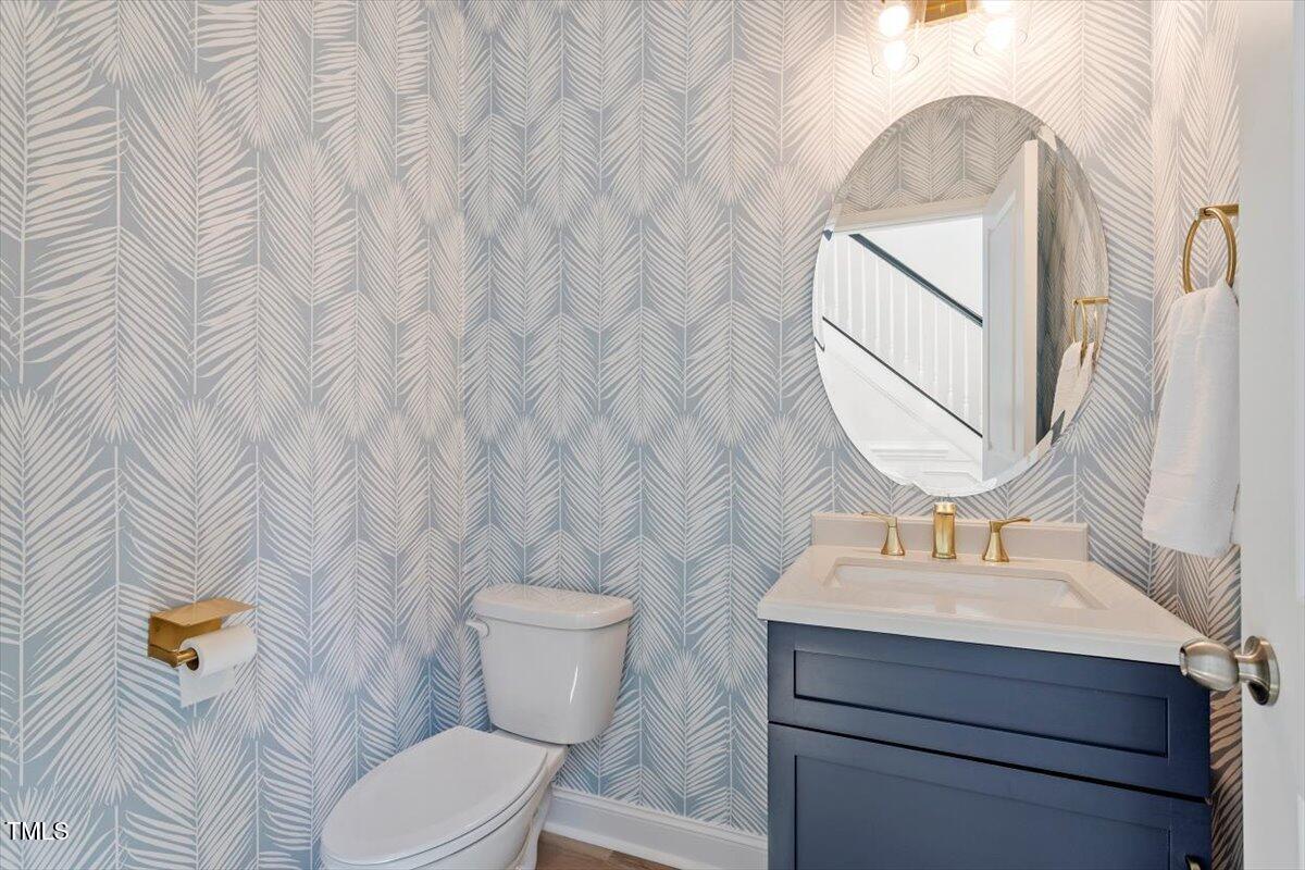 225 Mayfield Drive Apex, NC 27539 - Photo 20 of 41 a bathroom with a toilet sink and mirror