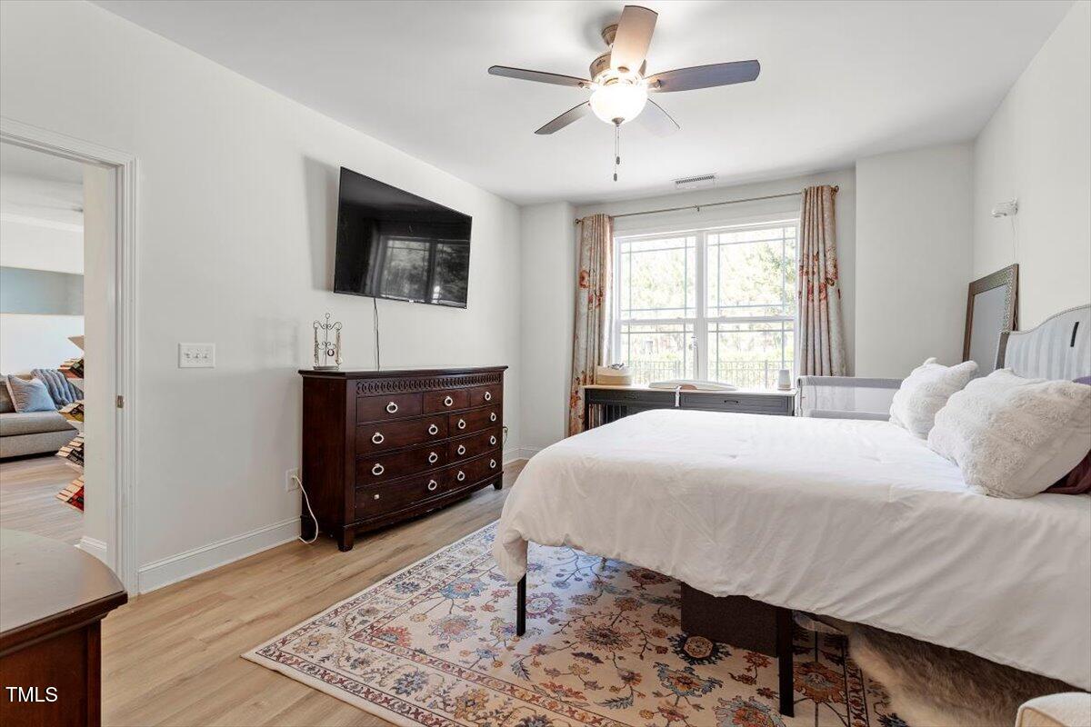 225 Mayfield Drive Apex, NC 27539 - Photo 22 of 41 a bedroom with a bed and a television