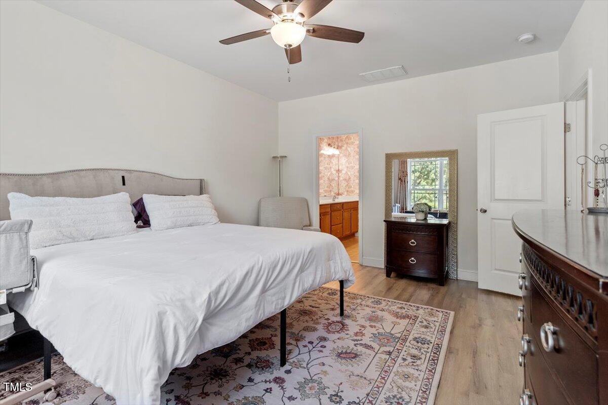 225 Mayfield Drive Apex, NC 27539 - Photo 23 of 41 a bedroom with a bed and a dresser