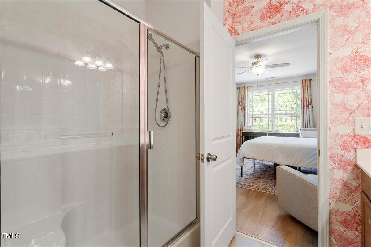 225 Mayfield Drive Apex, NC 27539 - Photo 25 of 41 a bathroom with a tub shower and window