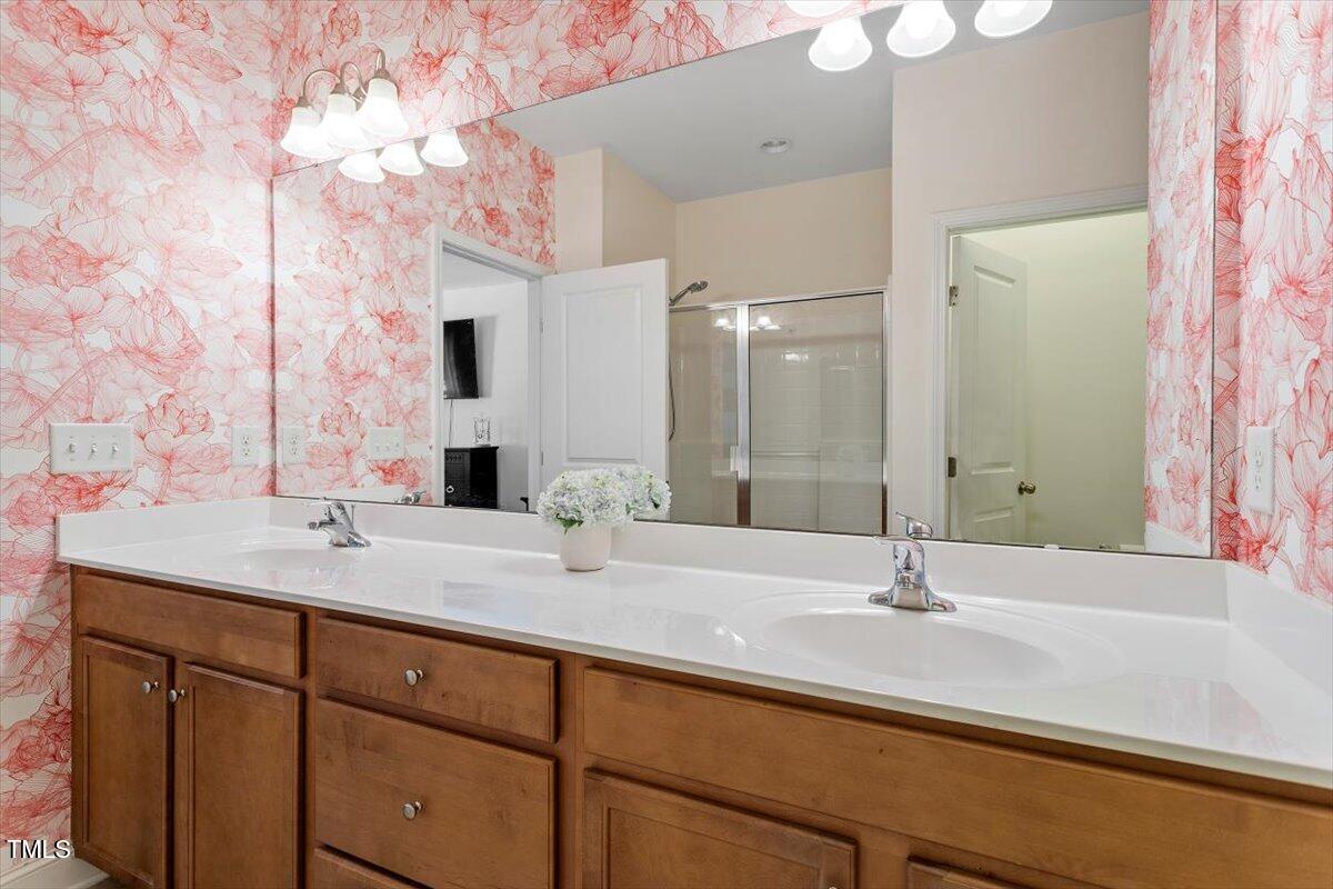 225 Mayfield Drive Apex, NC 27539 - Photo 26 of 41 a bathroom with a sink and a mirror