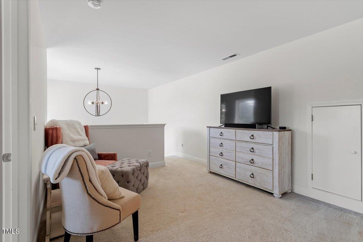 225 Mayfield Drive Apex, NC 27539 - Photo 28 of 41 a room with furniture and flat screen tv