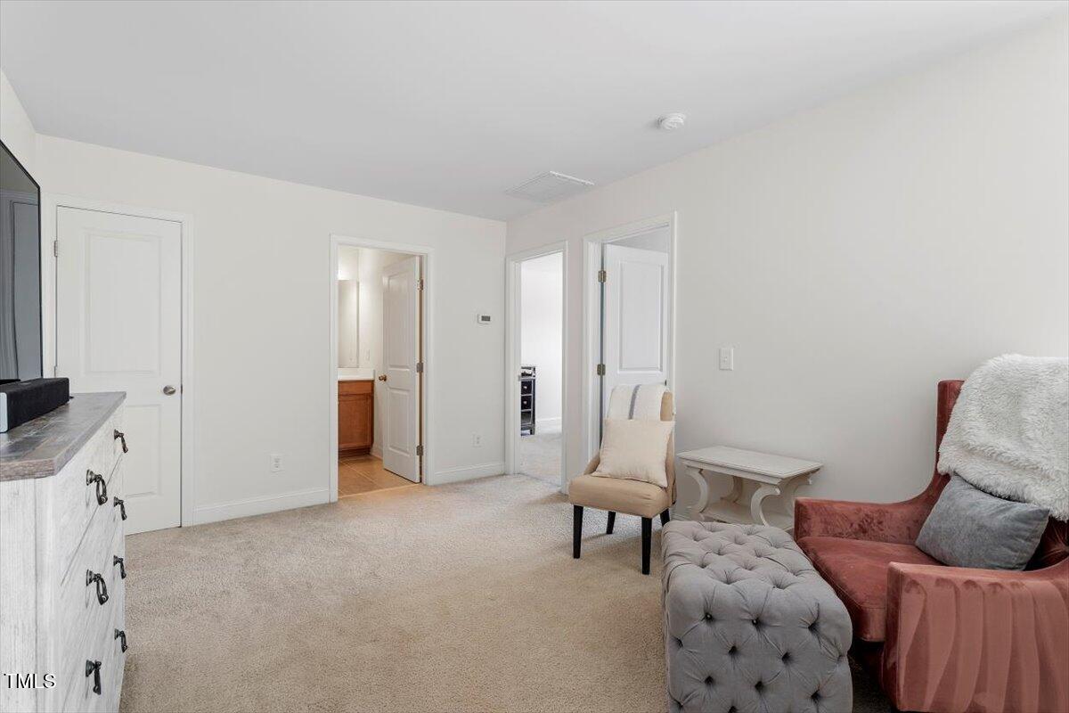 225 Mayfield Drive Apex, NC 27539 - Photo 29 of 41 a living room with furniture and a chair