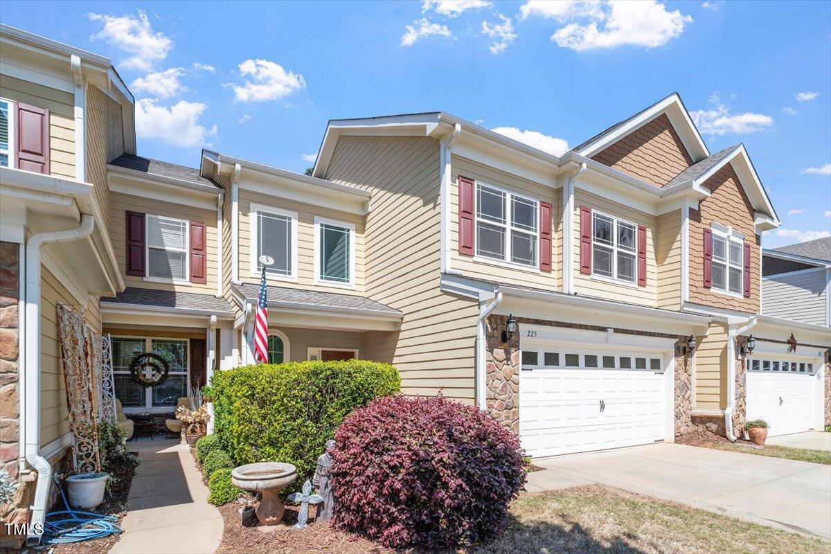 225 Mayfield Drive Apex, NC 27539 - Photo 3 of 41 a front view of a house with a garden