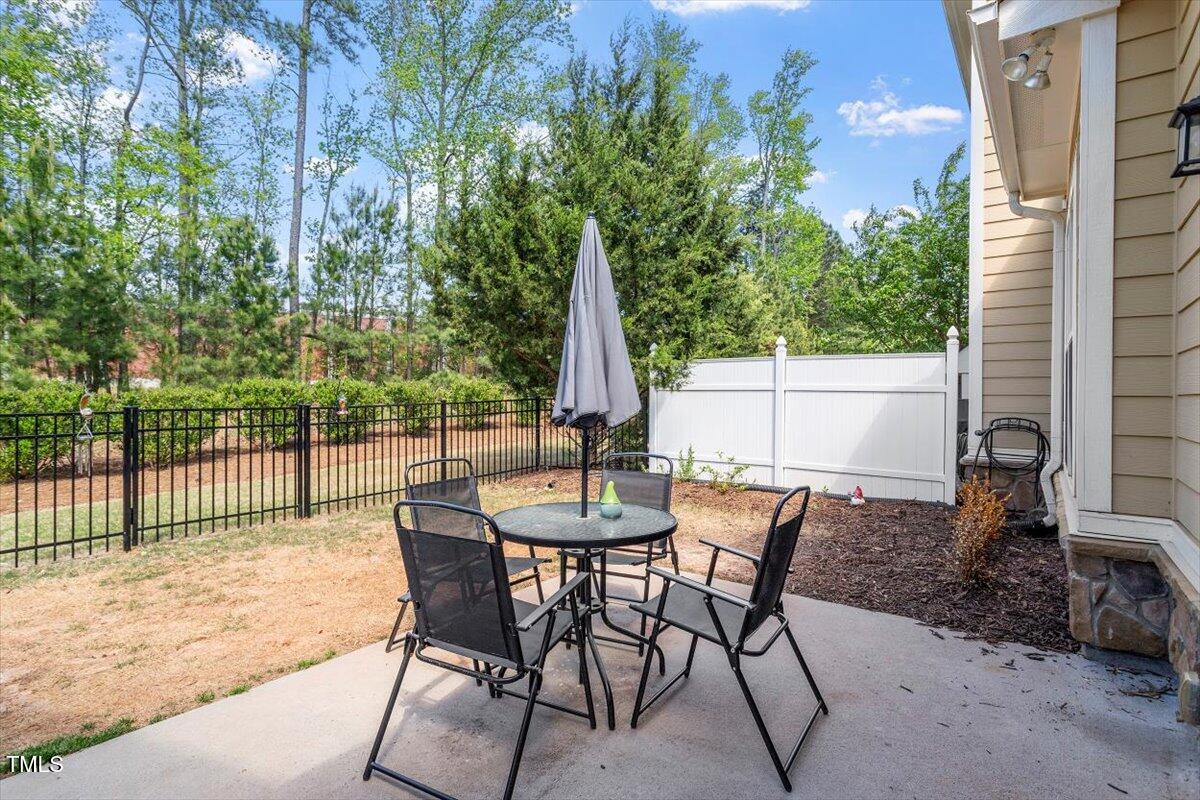 225 Mayfield Drive Apex, NC 27539 - Photo 33 of 41 a view of a patio with a table and chairs