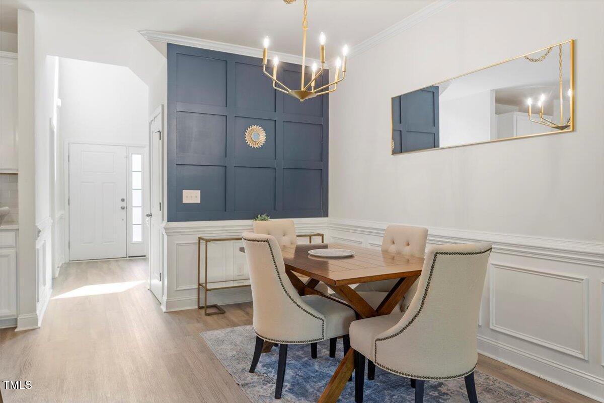 225 Mayfield Drive Apex, NC 27539 - Photo 8 of 41 a view of a dining room with furniture and wooden floor