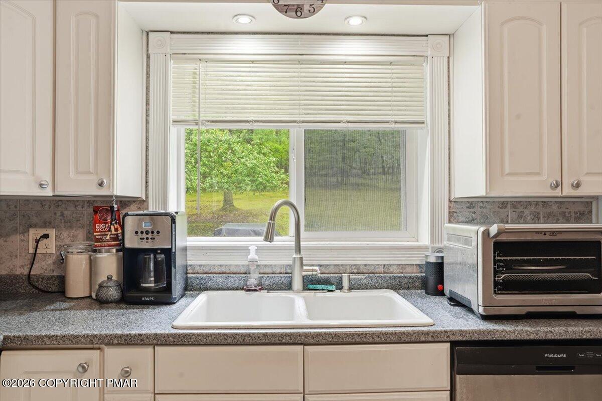 232 Garrity Road Hawley, PA 18428 - Photo 27 of 57 a kitchen with granite countertop a sink and a stove