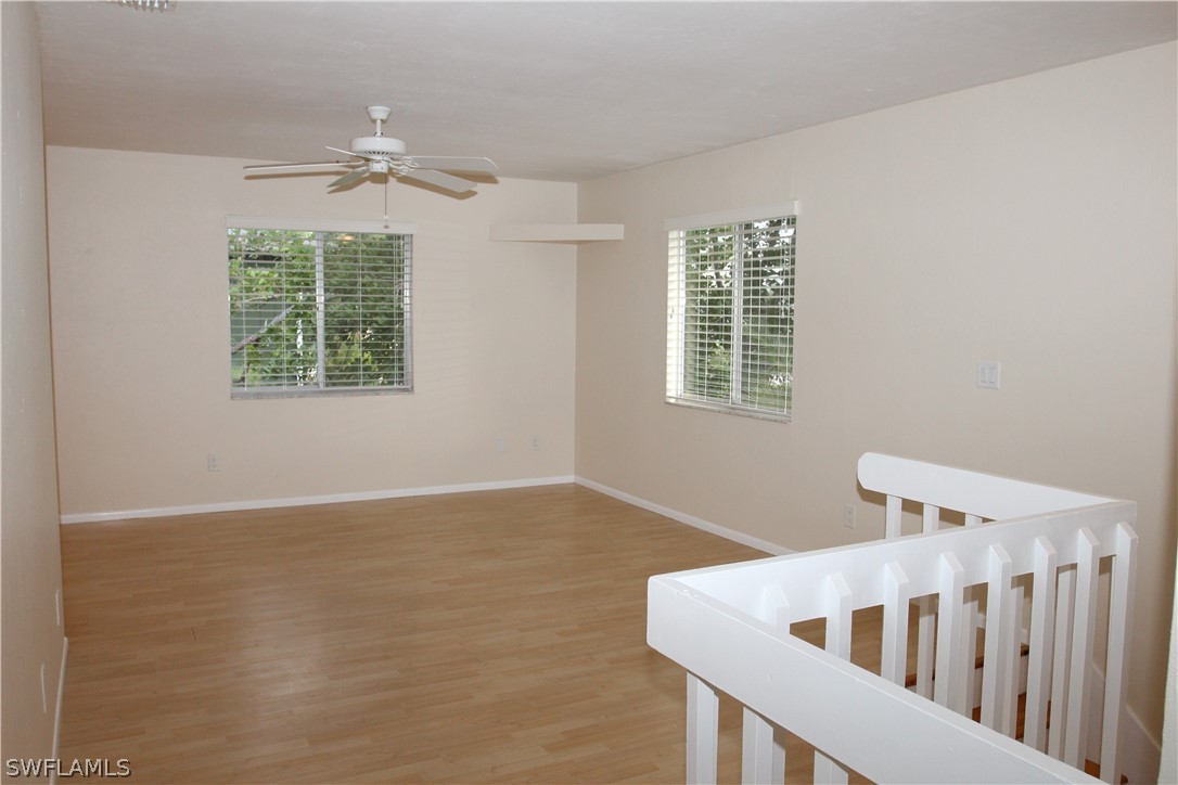 8461 Cardinal Road Fort Myers, FL 33967 - Photo 5 of 19 a view of an empty room with wooden floor and a window