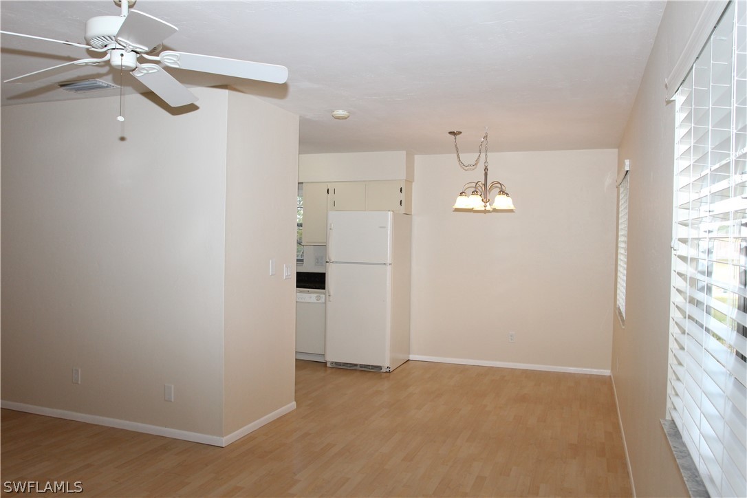 8461 Cardinal Road Fort Myers, FL 33967 - Photo 6 of 19 wooden floor in an empty room with a window