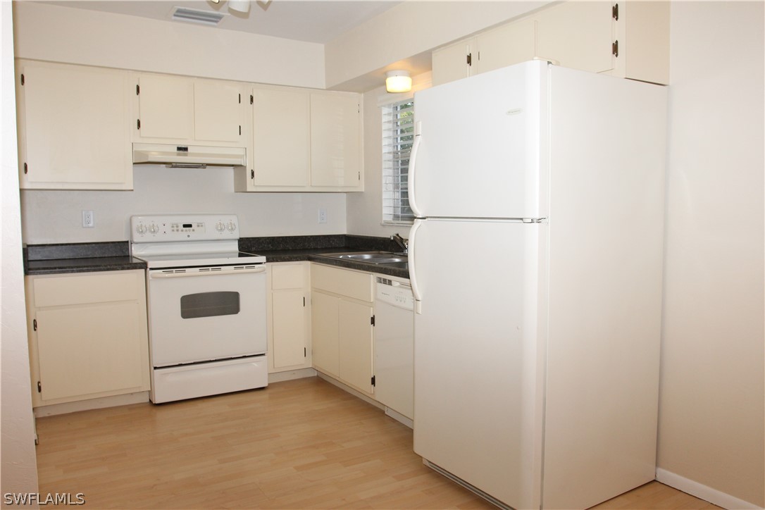 8461 Cardinal Road Fort Myers, FL 33967 - Photo 7 of 19 a white refrigerator freezer sitting in a kitchen