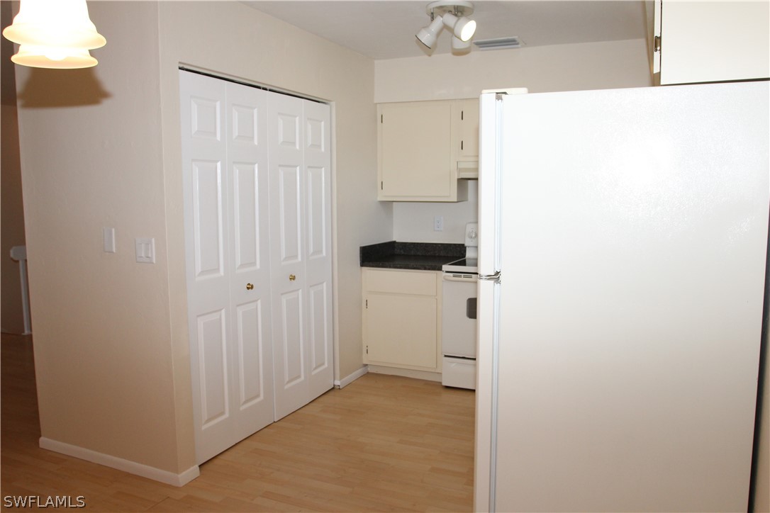 8461 Cardinal Road Fort Myers, FL 33967 - Photo 8 of 19 a view of a kitchen from the hallway