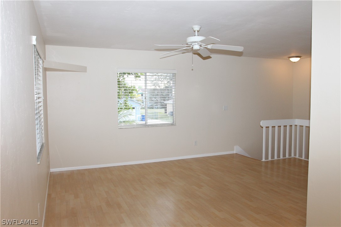 8461 Cardinal Road Fort Myers, FL 33967 - Photo 9 of 19 en empty room with windows and chandelier fan