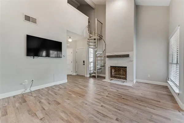 a view of a livingroom with a fireplace a window and a fireplace
