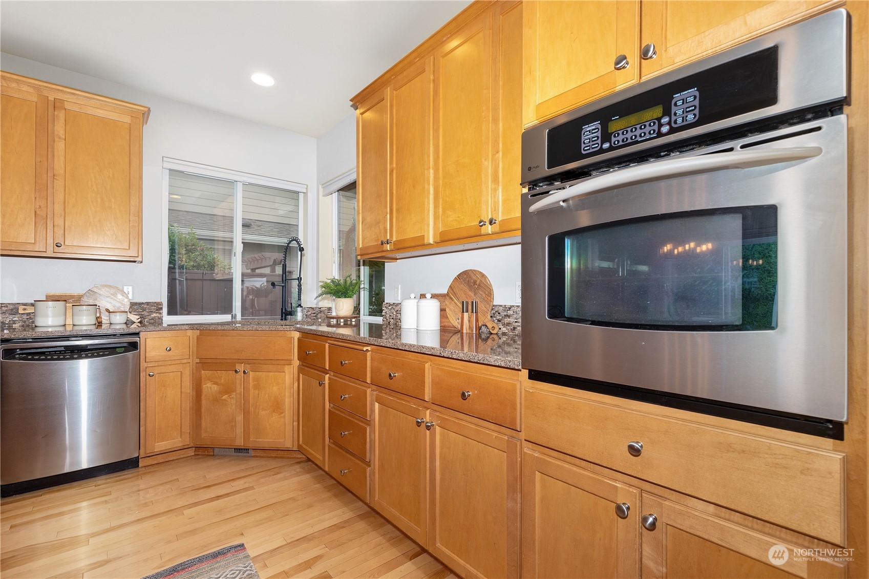 16722 166th Place Southeast Renton, WA 98058 - Photo 11 of 35 a kitchen with stainless steel appliances a stove microwave and sink