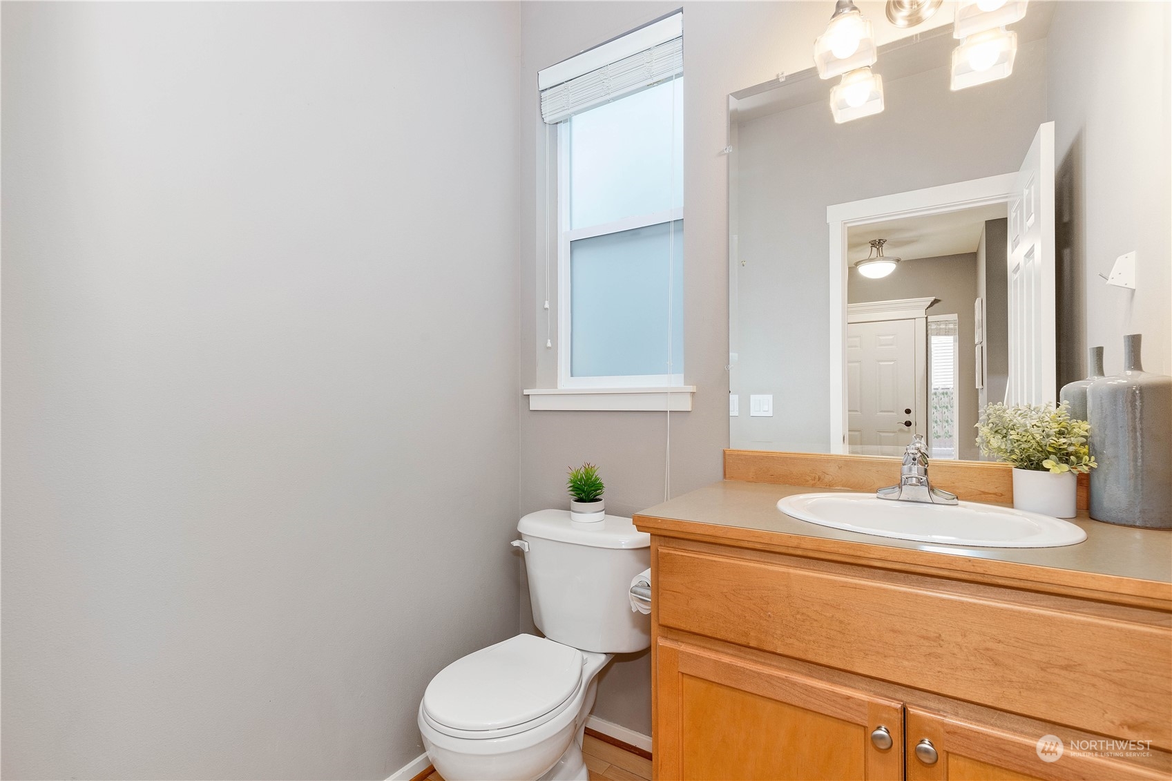 16722 166th Place Southeast Renton, WA 98058 - Photo 15 of 35 a bathroom with a granite countertop toilet sink and mirror